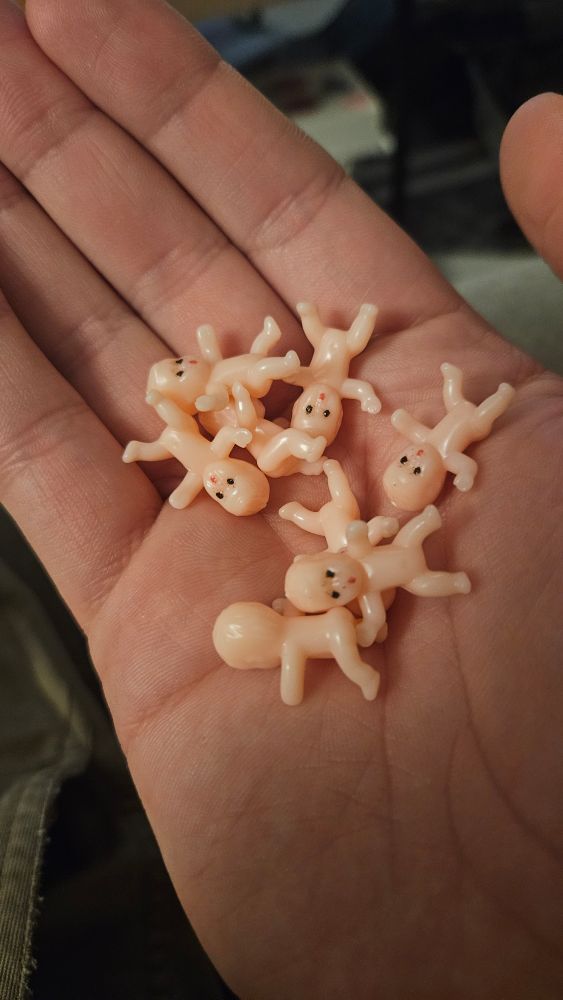 A handful of tiny plastic babies