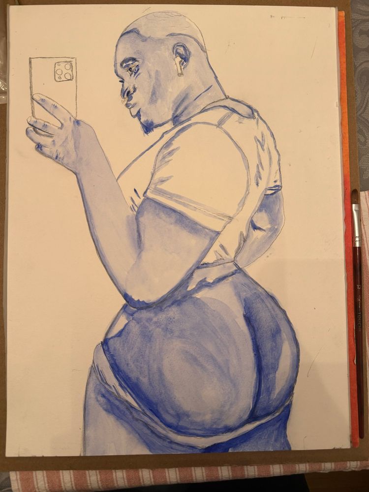 A gouache painting in progress, done in rich blue monochrome tones, features a confident, full-figured Black person taking a mirror selfie. They are turned in profile, looking over their shoulder with a soft, knowing expression. Their head is shaved, and they wear a short beard and AirPods. The subject holds a smartphone with four camera lenses visible on the back. They are dressed in a fitted t-shirt and partially pulled-down pants, emphasizing the curve of their hips and backside. The blue undertones give the figure emotional depth, shadow, and softness, celebrating gender non-conforming beauty and body positivity. The background is left blank, directing focus entirely on the subject. A red-handled paintbrush rests to the right side of the canvas, signaling that this is a work in progress.

