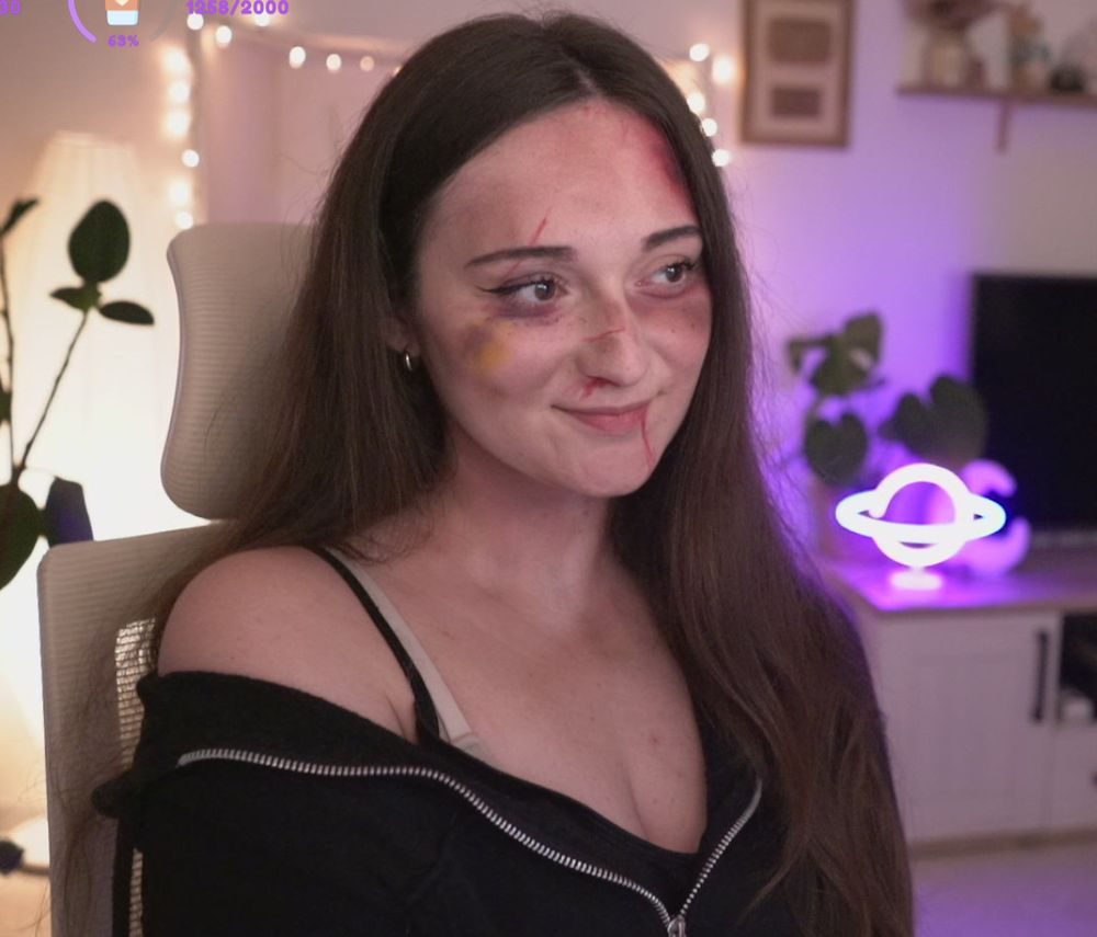 Screenshot of me on facecam with fake bruises, scratches and blood marks on my face to match the game's style