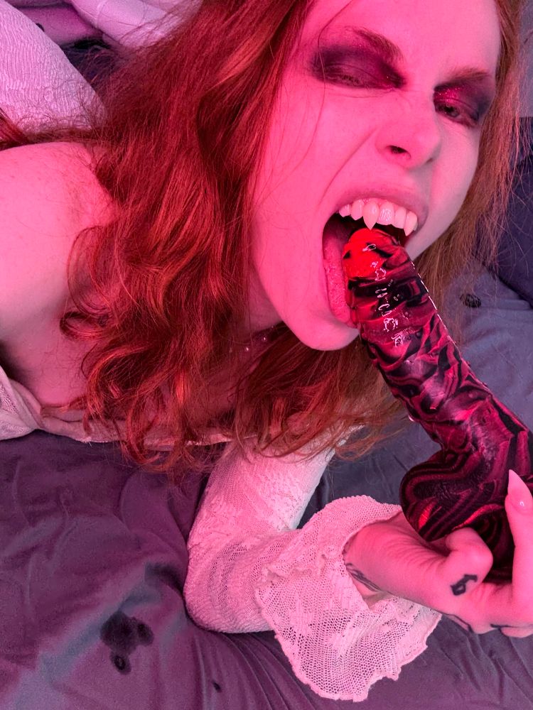 Fangs! Oh how sharp, hovering over the tip of that toy dildo’s head. Despite it being slick and shiny with spit, drooled droplets wetting the bedsheets below… Fox takes great care to not harm such delicate (pretend) places, don’t worry.