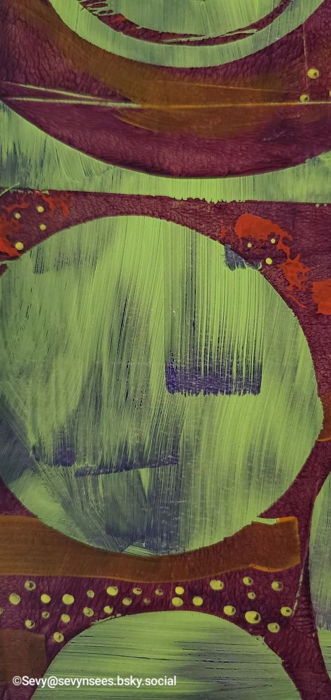 Abstract monoprint close up. The colors used are prism violet, cadmium red light, cadmium orange, yellow green, purple and yellow.