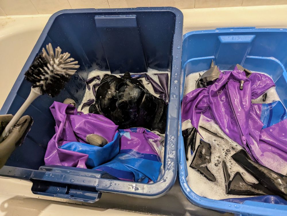 A tub of rubber dragons soaking in soapy water. 