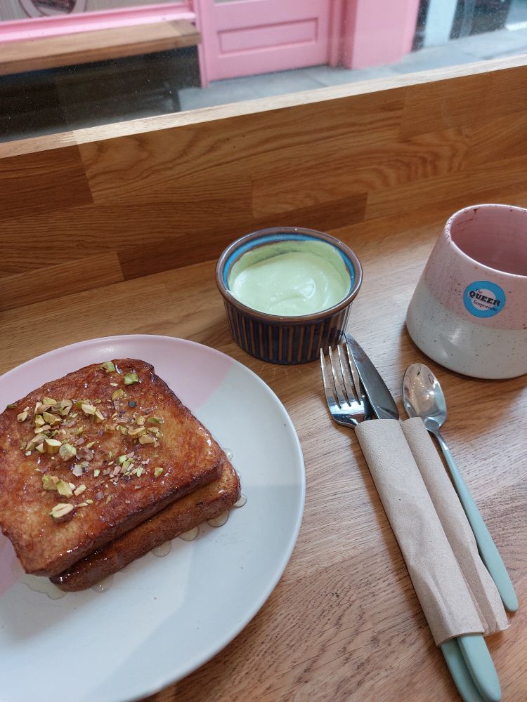 A photograph of some french toast, matcha cream cheese and hot chocolate