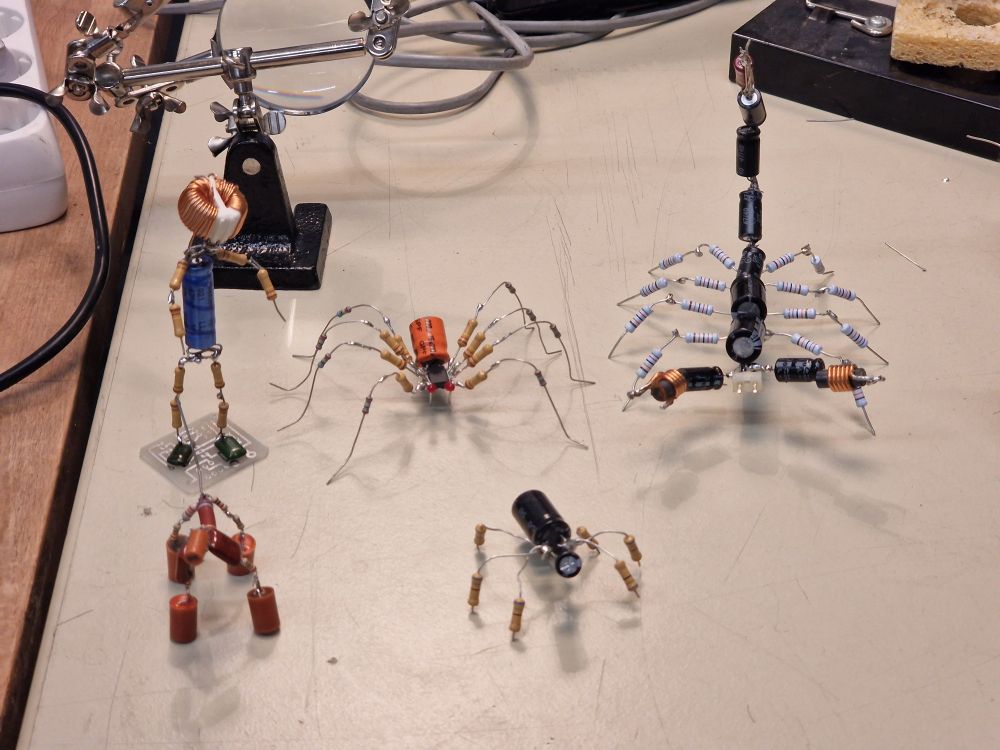 five small decorative creatures assembled out of electronics components