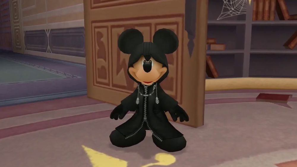 Mickey Mouse from Kingdom Hearts 2, wearing a black coat and accompanying hood. He's disguised as the game's main antagonists, Organization 13, and he looks pretty dang silly, to be quite honest. Like, really comical. 