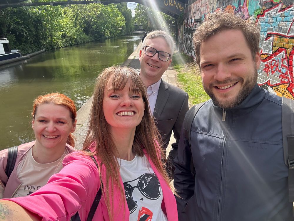 a four people who met online in a group selfie in london