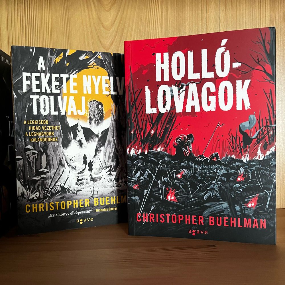 Two books standing next to each other. The left is The Blacktongue Thief, and the one on the right is The Daughters' War. Both of them are by Christopher Buehlman but these are the Hungarian translations published by Agave.