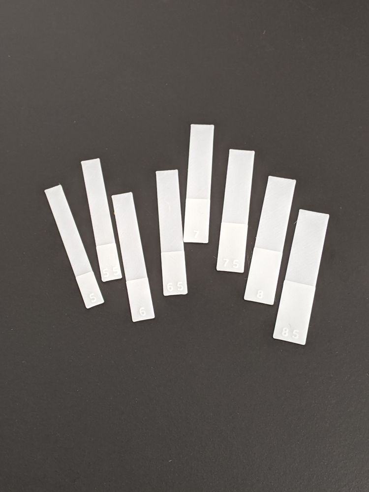 A set of 3D printed rectangles with their width embossed on them