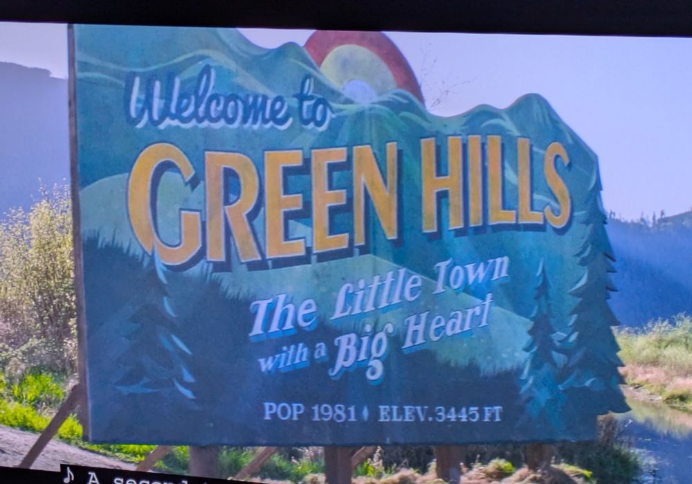 Still from Sonic 2 depicting a sign that reads "Welcome to Green Hills / The Little Town when a Big Heart"