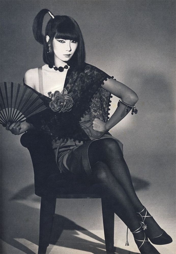 photograph of Sayoko Yamaguchi posing on a chair.