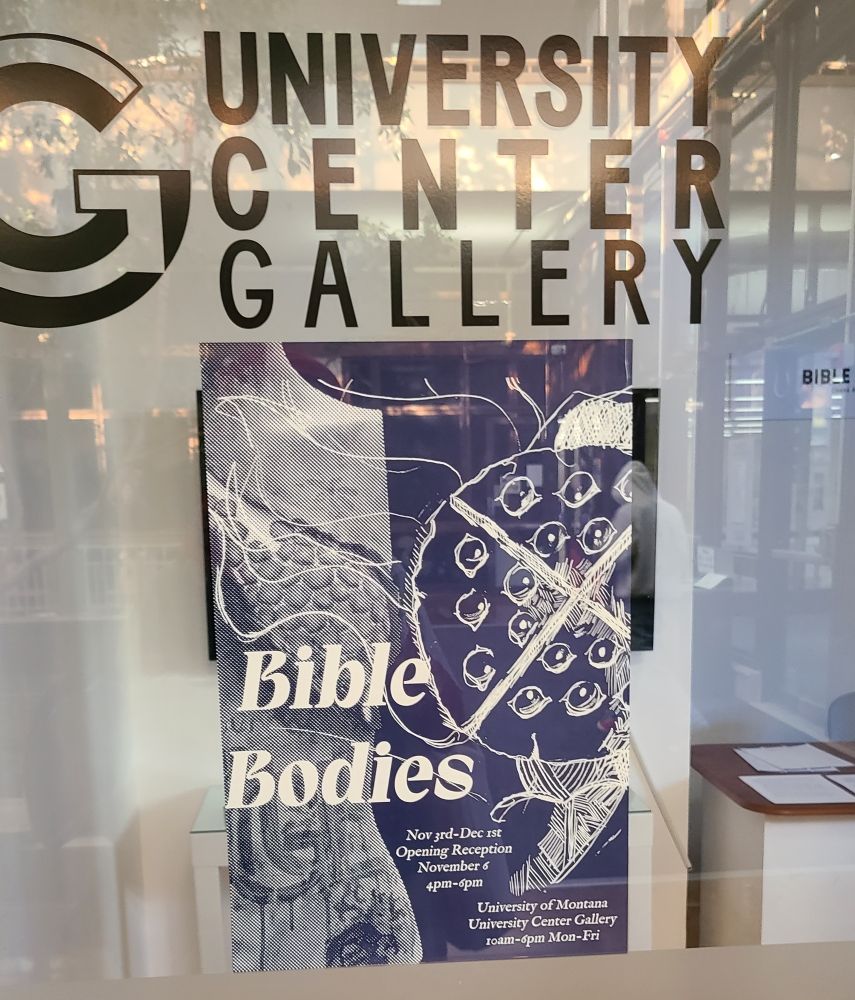 A blue poster is on some glass that says "University Center Gallery." The poster has half a mannequin and a sketch of a round faced creature with many eyes and an X over the face. The poster says "BIBLE BODIES" and some details for opening night as well as length of exhibit