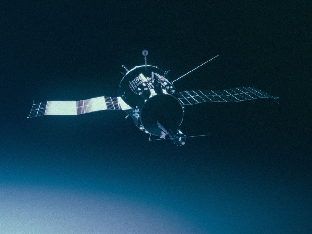 The TKS: A soviet spacecraft with a main hull, long nose, and two solar panels.