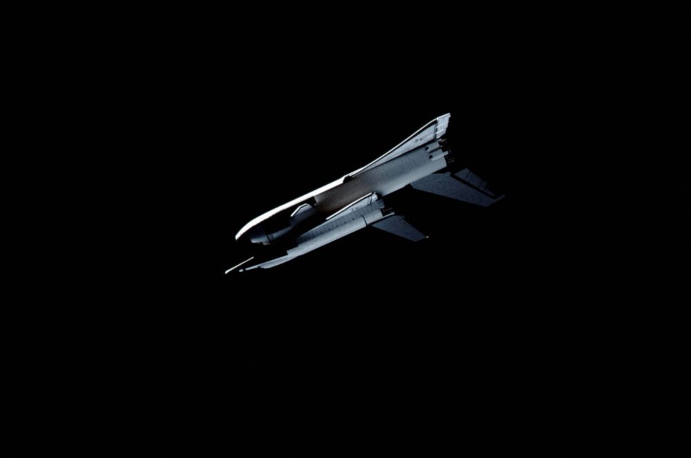 An early space shuttle concept showing an orbiter being launched on another space shuttle-style spacecraft.