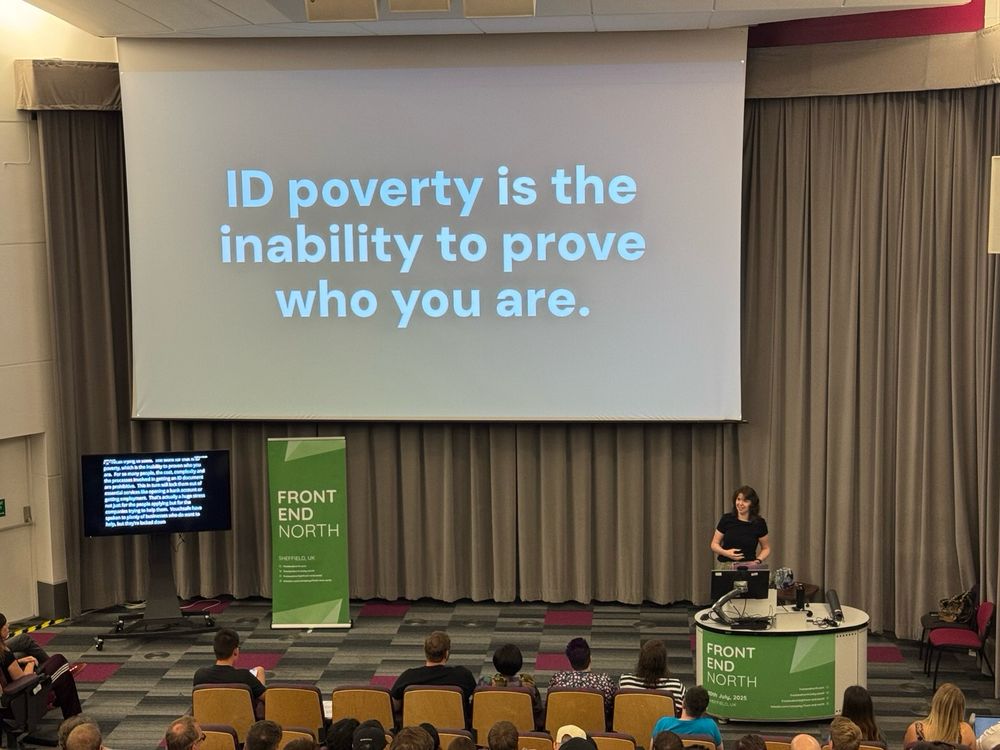 Amy presenting a slide reading "ID poverty is the inability to prove who you are"