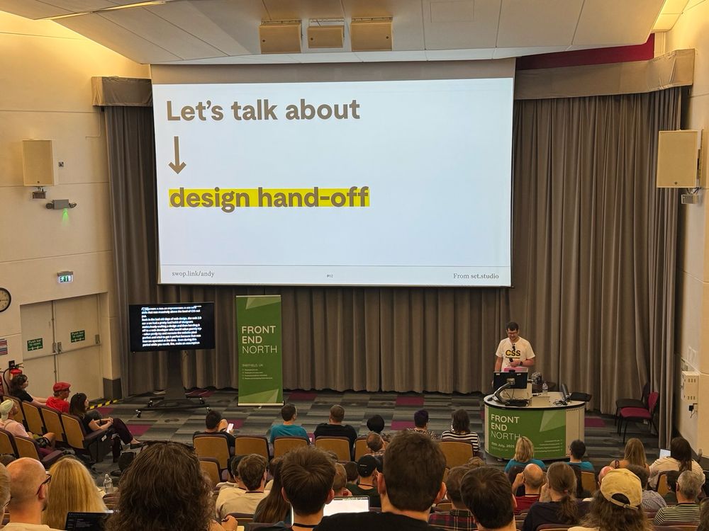 Andy Bell presenting. Slide reads "Let's talk about (arrow) design hand-off"