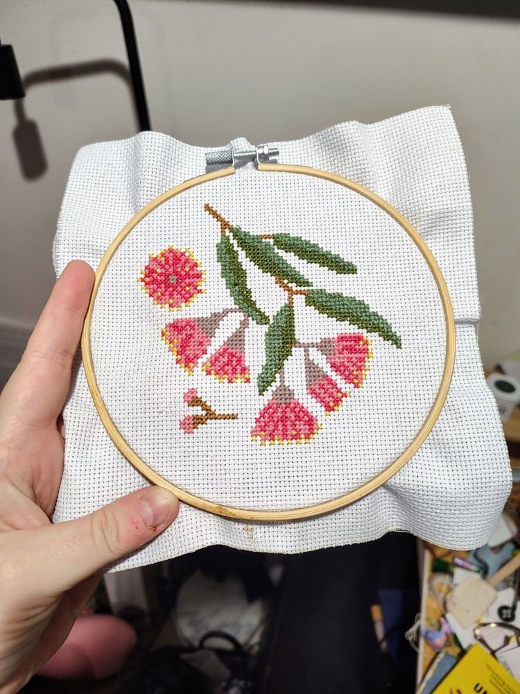 A finished cross stitch of gum blossom flowers.