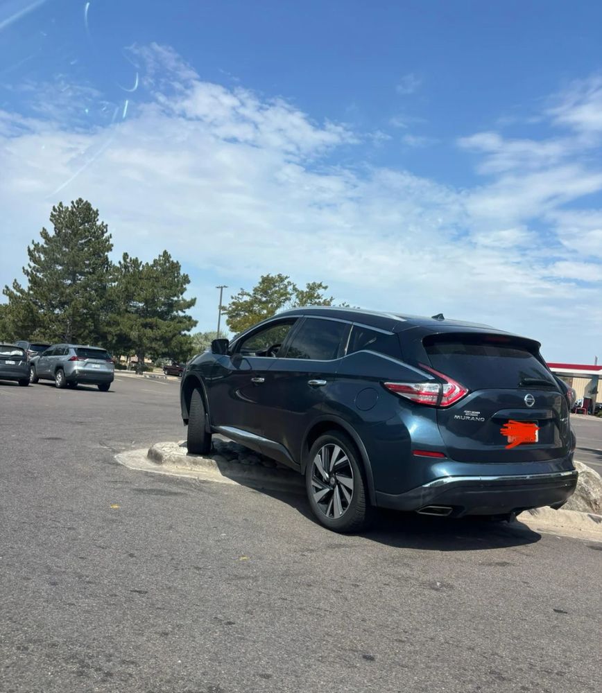 The Mississippi Ave rock claims another victim. A vehicle has become stuck on a piece of ornamental rock in a parking lot.