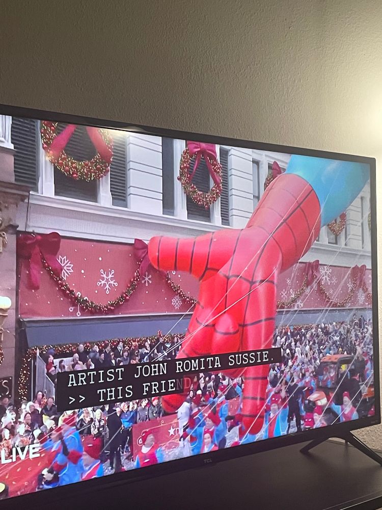 Spider-Man balloon with the caption ARTIST JOHN ROMITA SUSSIE.