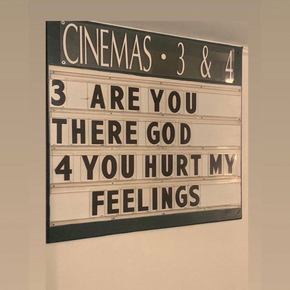 a movie marquee with the titles “ARE YOU THERE GOD” and “YOU HURT MY FEELINGS”