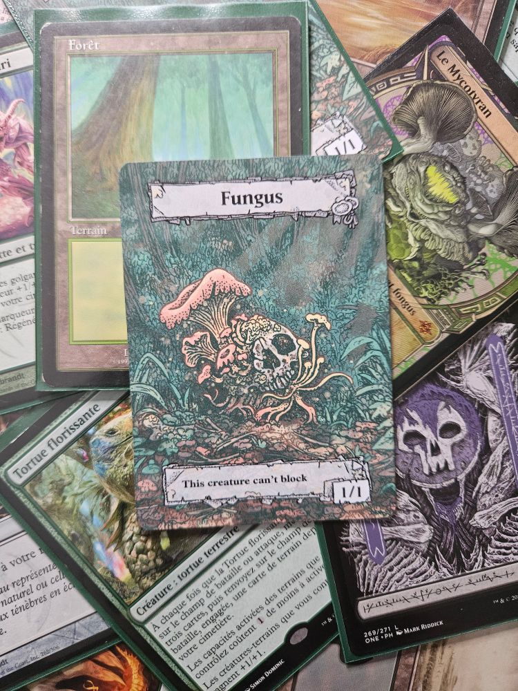 A homemade token card for mtg. On the card a mushroom growing on a human skull. The title of the card is "Fungus" and the text is "this creature can't block". 