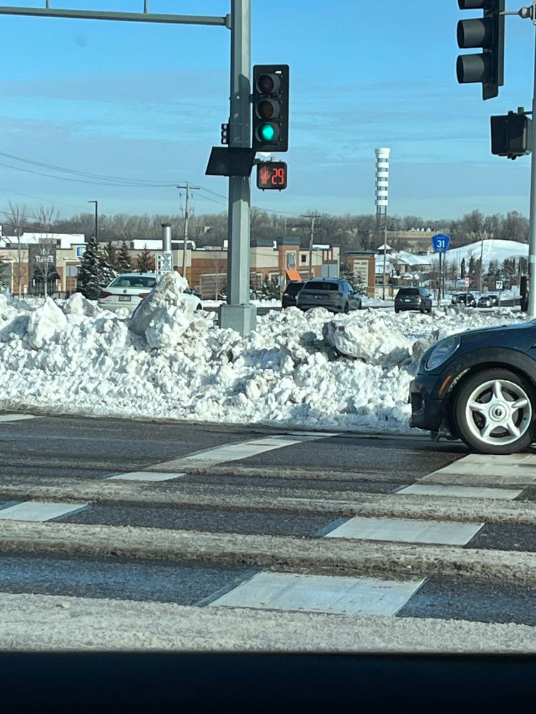 a curb cut burried in a few feet of snow at a controlled intersection in eagan, mn. 