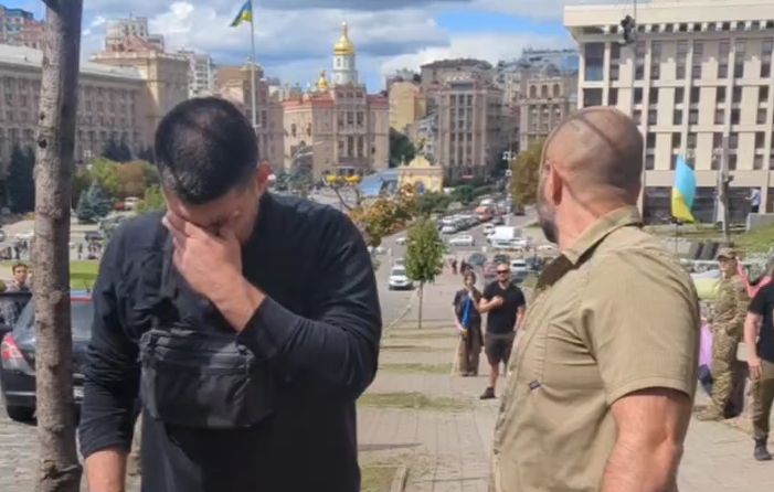 Kapustin covering eyes after being pepper sprayed