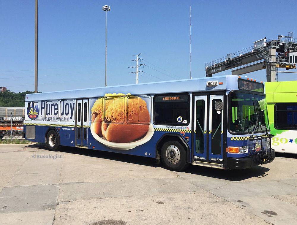 A Cincinnati bus with an advertisement wrap for Cincinnati chili.