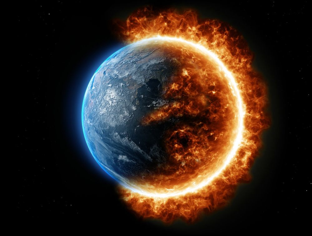 A photo of the earth with the right side engulfed in flame.