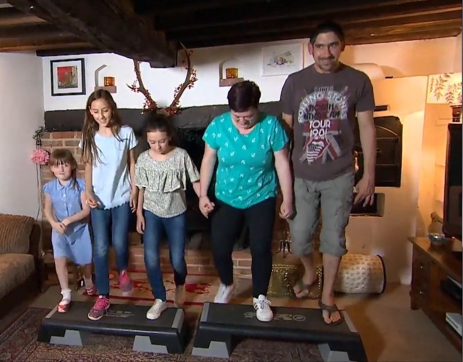 Photograph of family in living room using exercise steps together. Courtesy of BBC Look East (2020)
