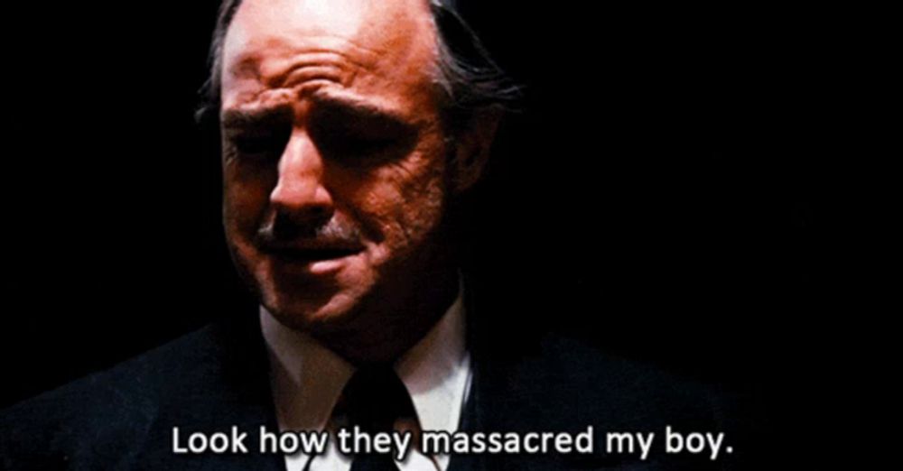 a man in a suit and tie is crying and says " look how they massacred my boy "