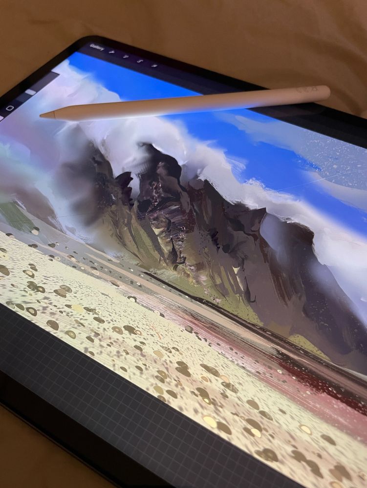 painting of an arid mountain and rolling clouds on an ipad