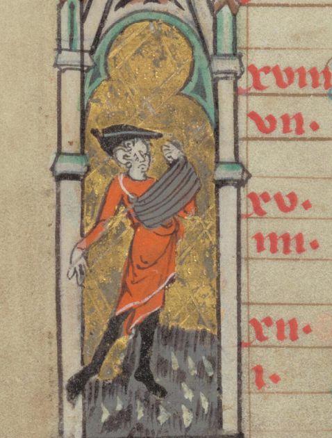 Medieval manuscript illustration showing a man wearing a red tunic, black hat, and black shoes, standing within an architectural frame with a gold background. He is holding a bag or basket at his waist, sowing seeds with one hand. The image is part of a calendar manuscript page with red text visible on the right.