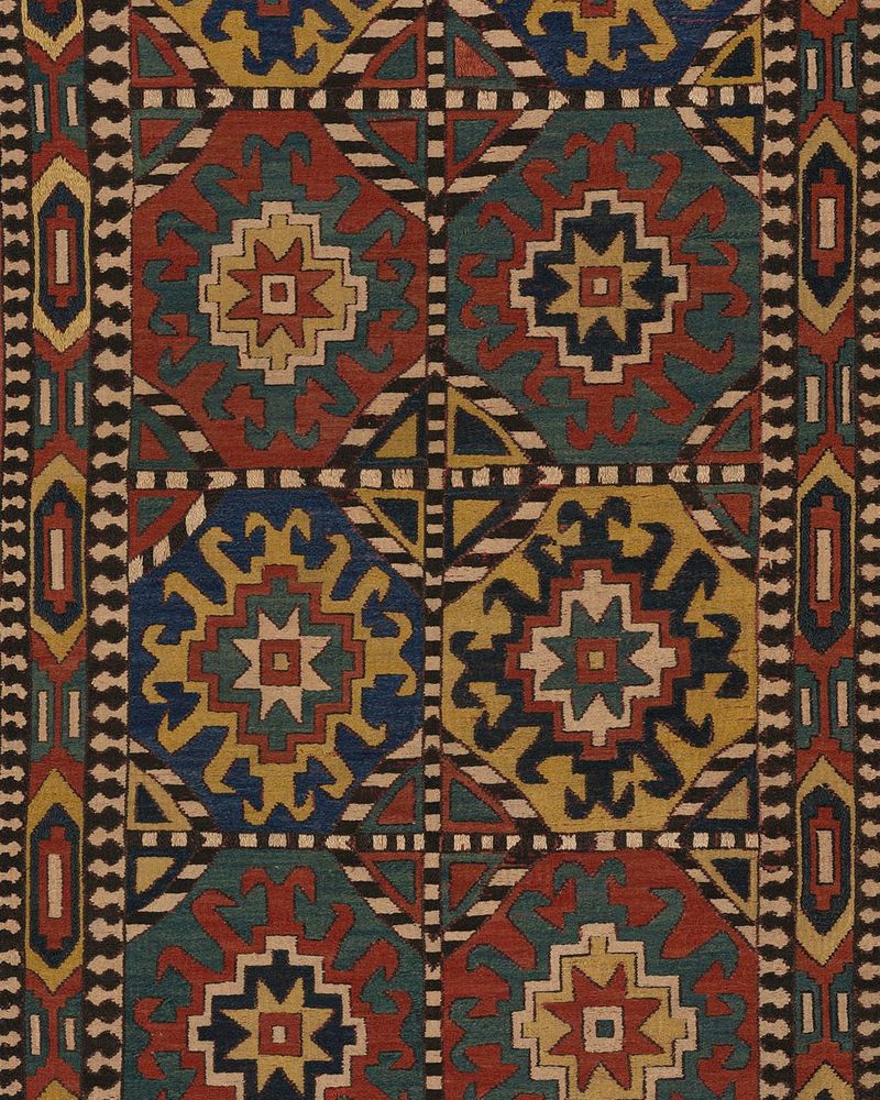 Embroidery with checkerboard bands of black and white squares and miniature crenellations divides this panel into eight sections, each with an eight-pointed star within a 'wheel of life' medallion.