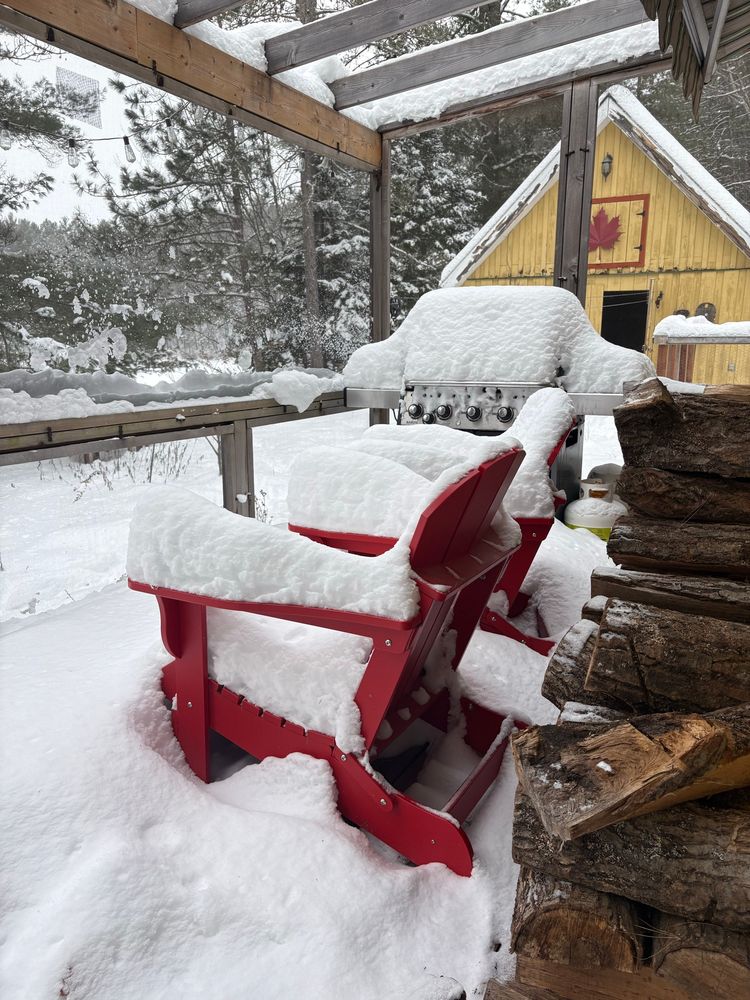 Snow-covered Muskoka chair
