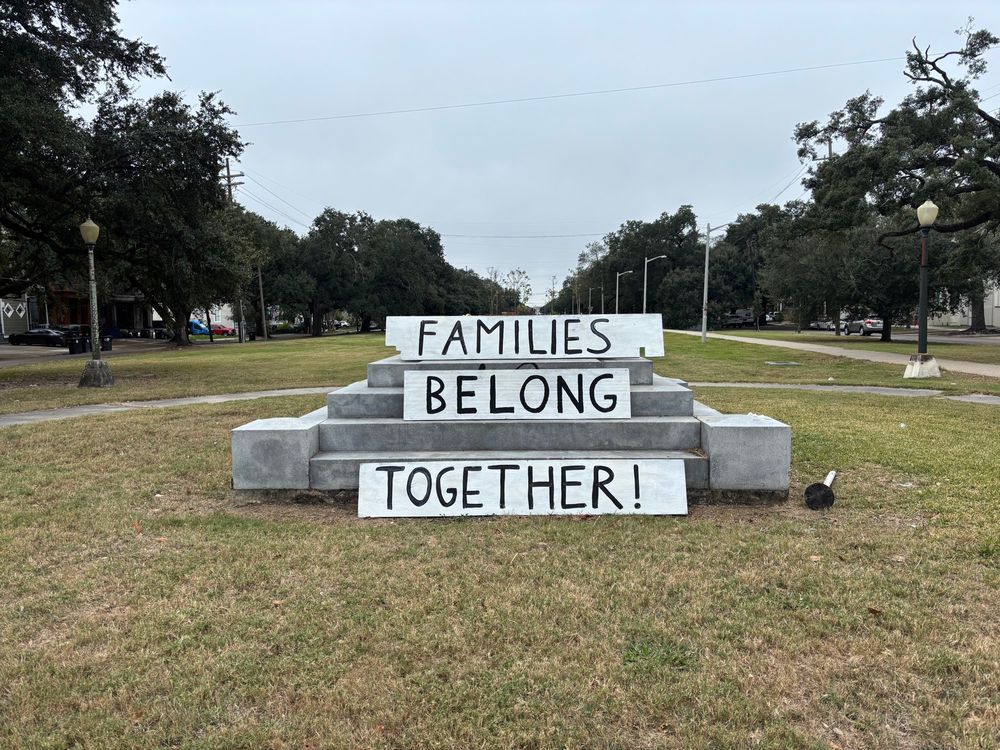 Park with signs reading:

FAMILIES BELONG
TOGETHER!
