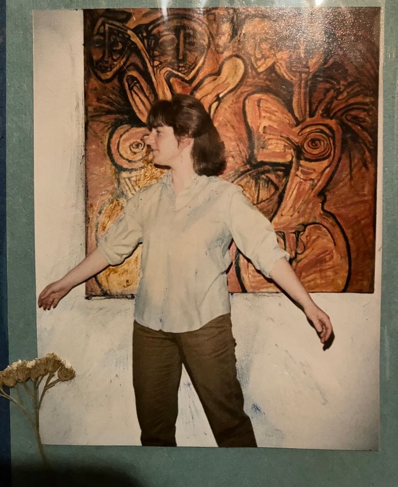 A twenty-something me, in front of painting by Jorge Soto Sanchez 