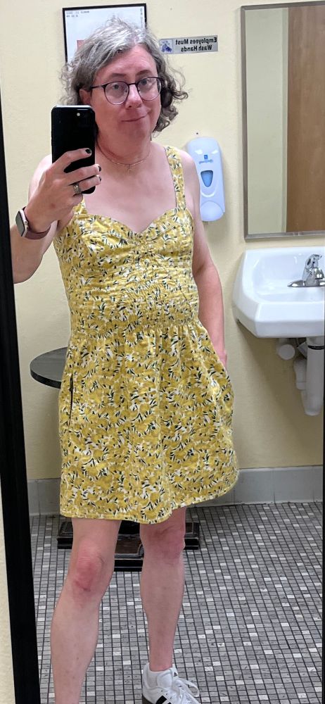 Me in a yellow floral dress wearing white sneakers 