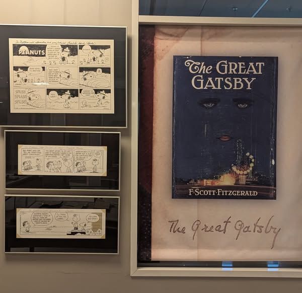 The original art for three Peanuts comic strips featuring Gatsby.  On display at the University of South Carolina Hollings Library.