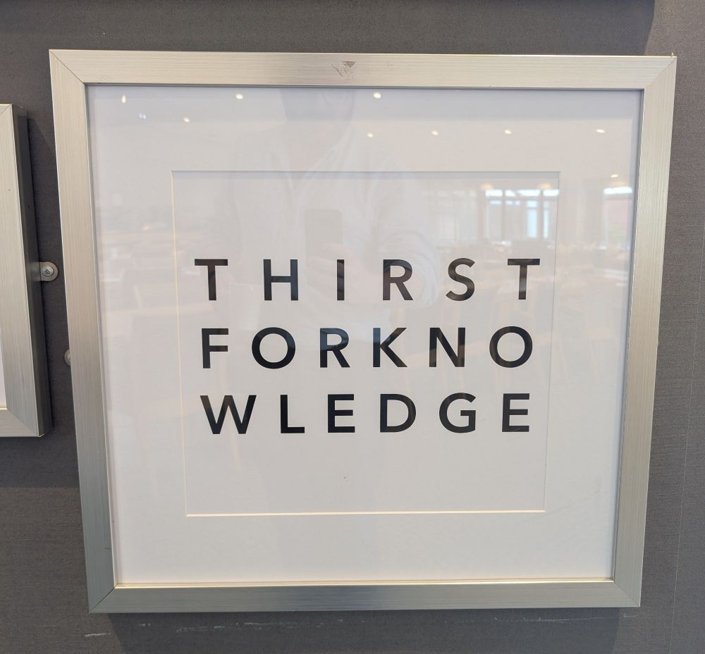 Framed print reading THIRST FOR KNOWLEDGE with awkward line breaks. 