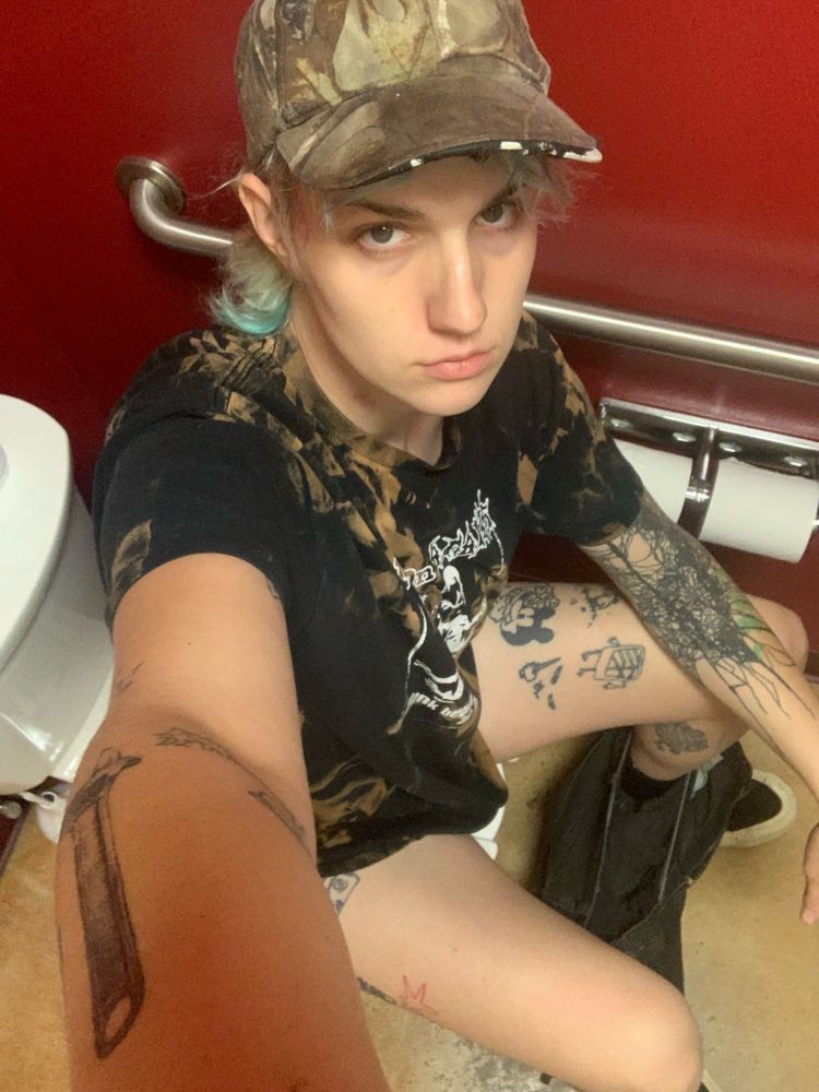 Selfie of me, high angle, sitting on a toilet. 