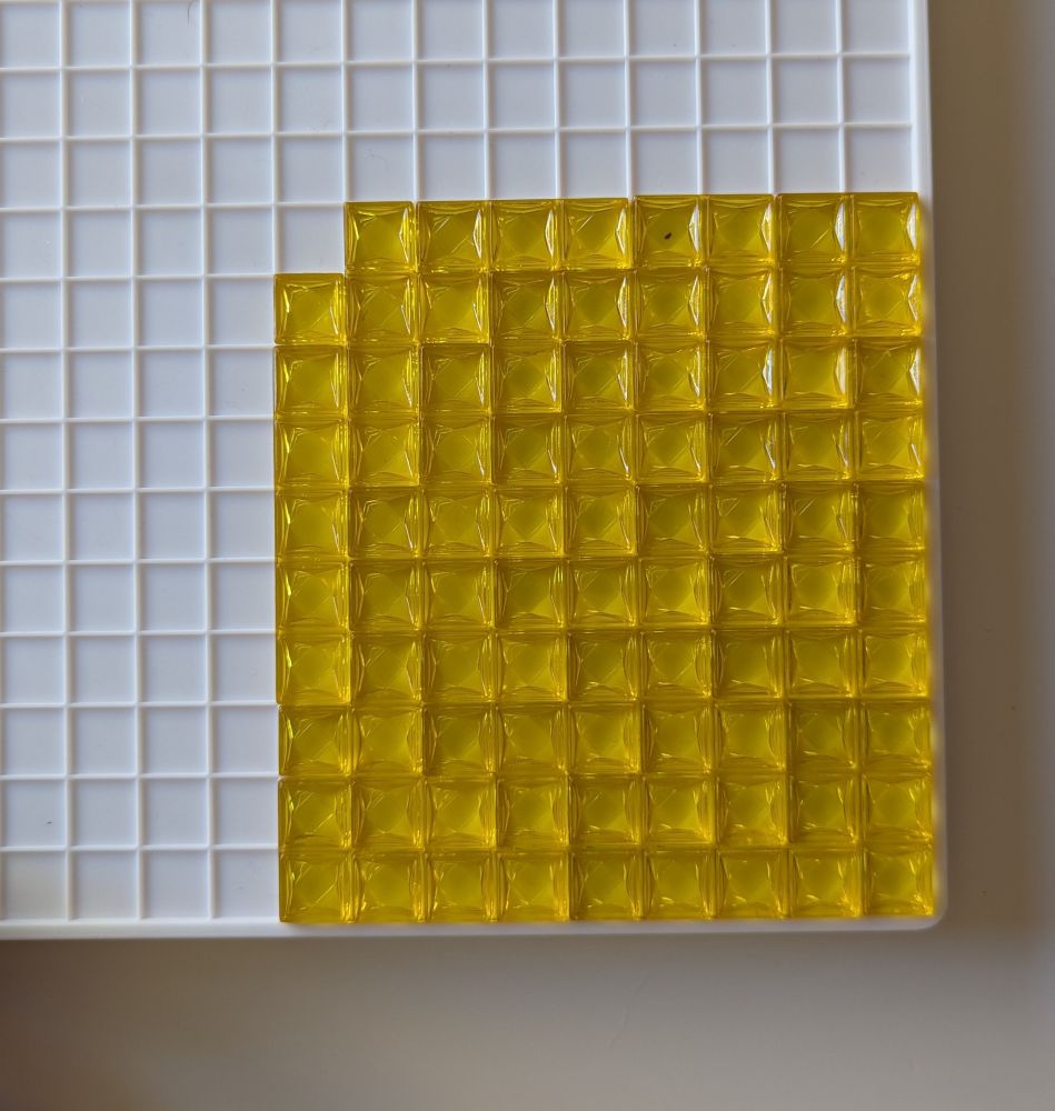 A full set of 21 yellow Blokus tiles all shoved into a compact 9x10 rectangle (minus one unit in the corner)