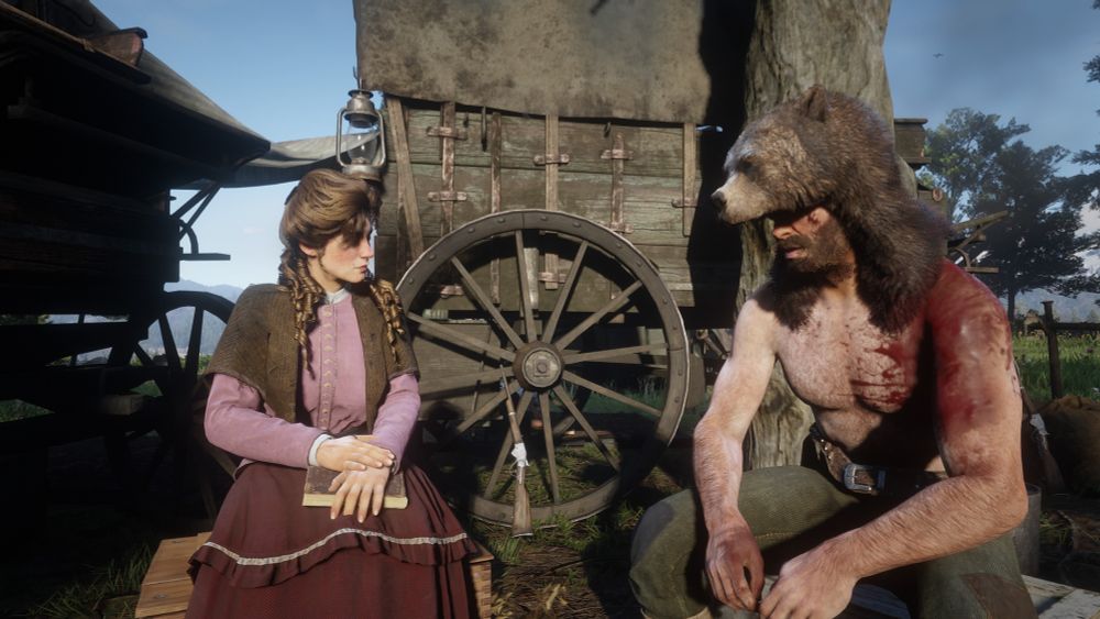 screenshot i made in RDR2. mary-beth is sitting on the left in a pink shirt, with a brown over the shoulder cardigan, long dark red/brown skirt. Arthur is topless, covered in blood and dirt, wearing green trousers and a bear hat. There is a wagon behind them and its daytime.