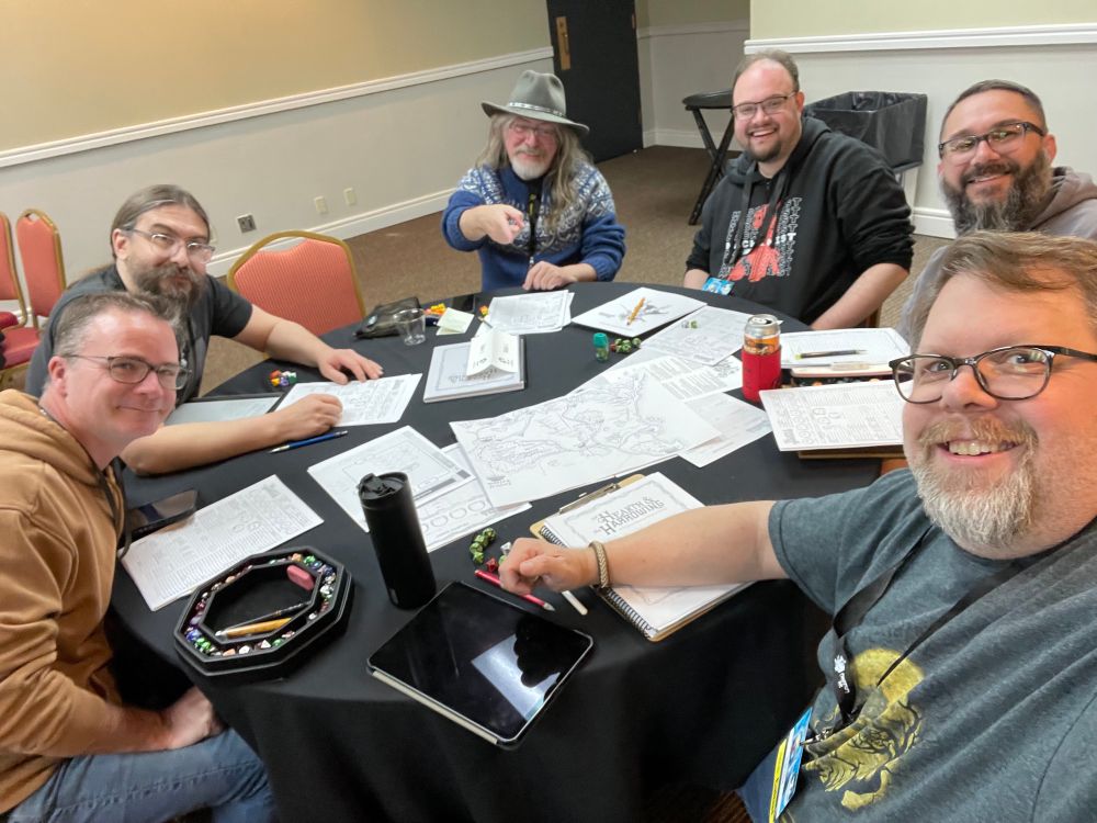 Table full of gamers playing ‘Of Hearth & the Harrowing’ at ChaosiumCon 2025.