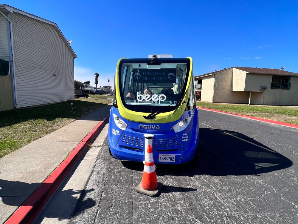 An autonomous vehicle with a traffic cone in front of it