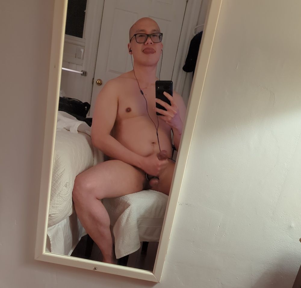 Gaysian Bator taking a mirror selfie while gooning out in a hotel room