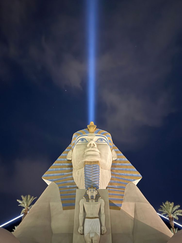 The sphinx at the Luxor Las Vegas at night with a beam of light rising above it