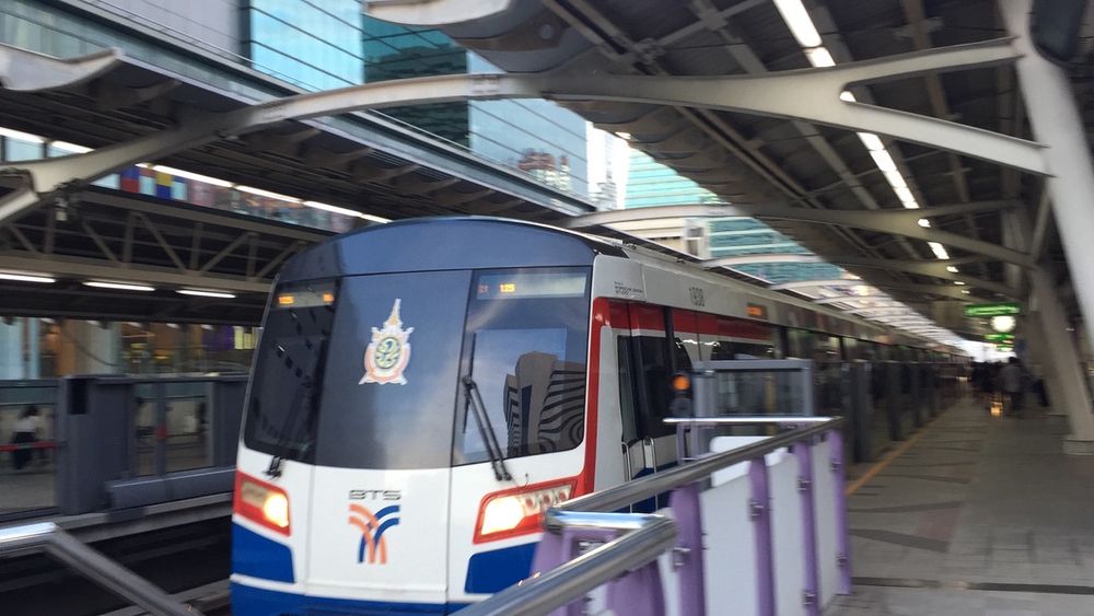 Skytrain departing Sala Daeng station, equipped with platform edge doors, on the BTS Silom Line