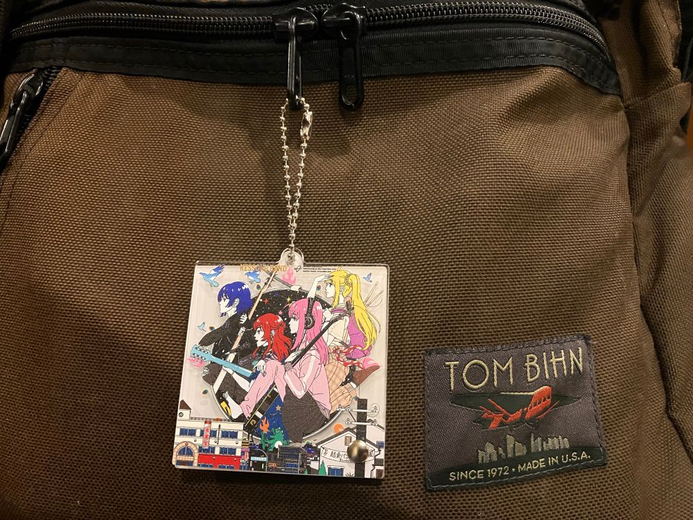 Kessoku Band album art illustration by Yusuke Nakamura of Asian Kung Fu Generation fame on a charm hanging from a Tom Bihn briefcase made in USA
