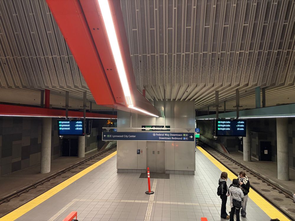 Platform directional signage indicating lines and stations with numbers