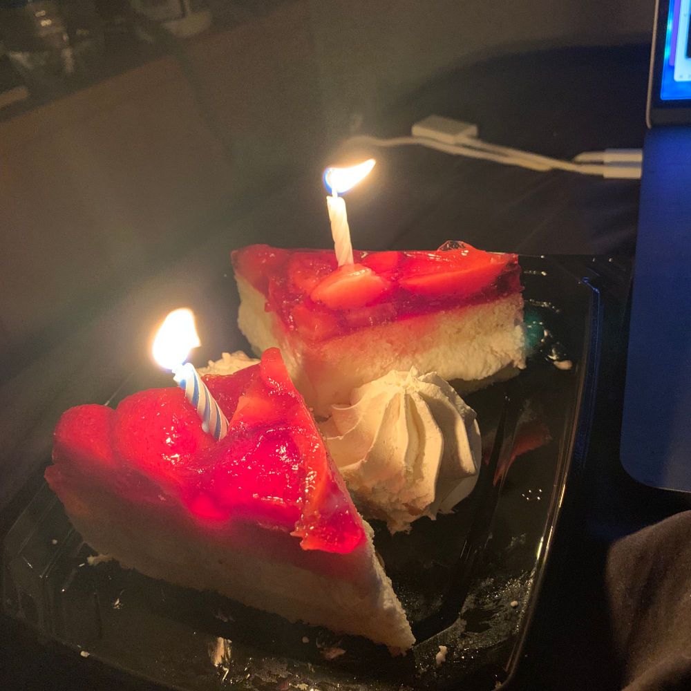 strawberry cake with candles on top.